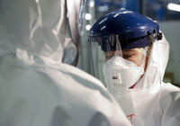 Checking_Personal_Protective_Equipment_ (PPE) _in_the_fight_against_Ebola_ (15650272810)